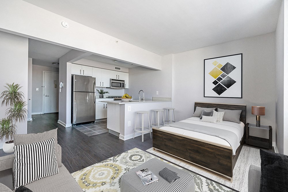 a studio apartment with a bed and a kitchen at 34 Berry, Brooklyn, New York